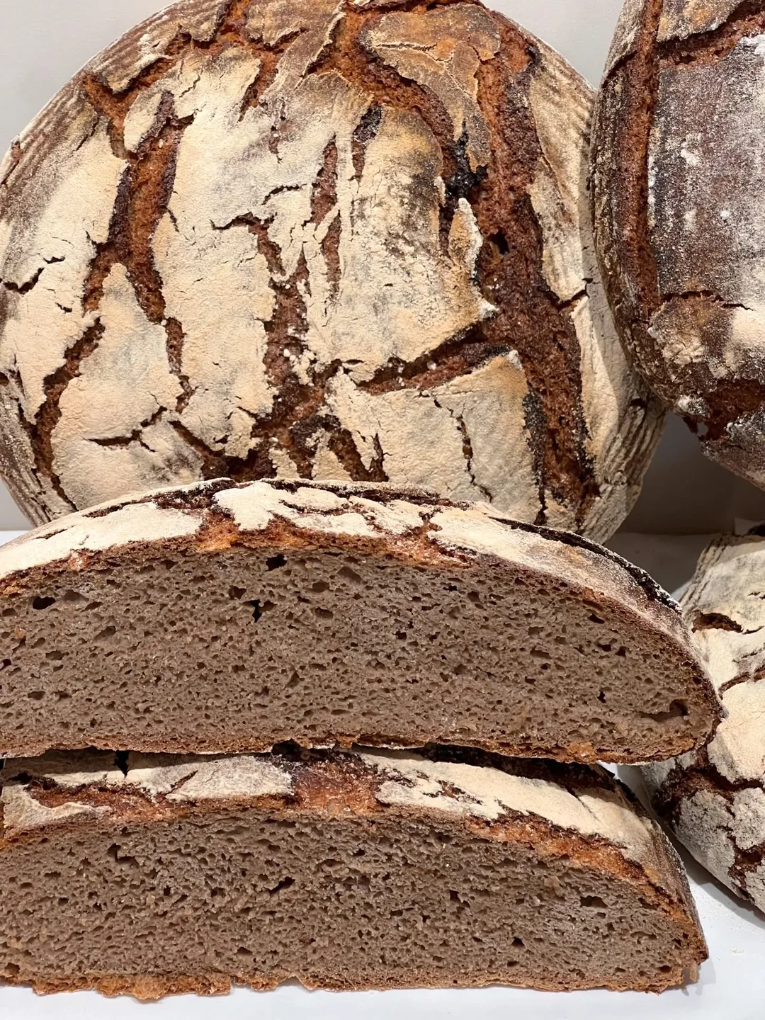 Rye bread cut in half, with a dense dark crumb
