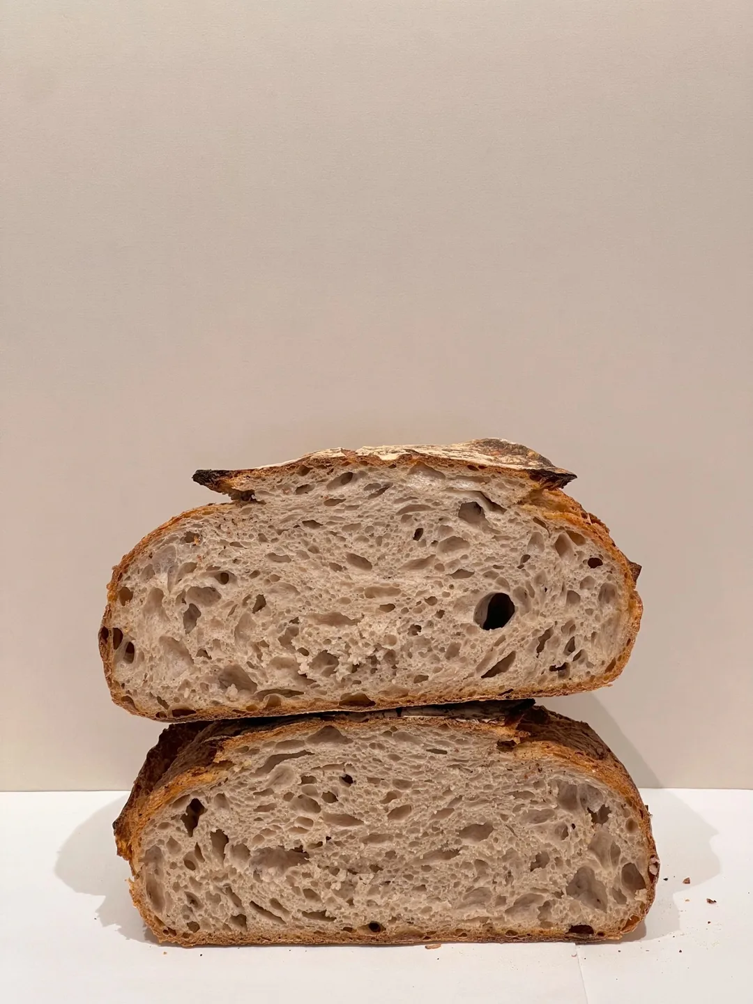 A loaf cut in half, showing its open crumb